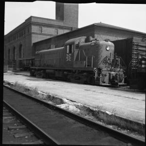Left 3/4 rear view of RS-3 #553 in McGinnis Livery in front of passenger station