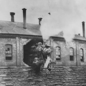 Hartford, CT roundhouse with engine #321 crashed thru the back wall with lead truck hanging over the abyss.