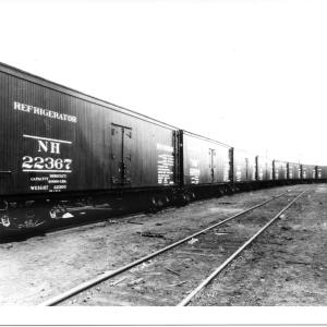 Line of 13 new wood refrigerator cars on an unidentified yard siding. First car is NH #22367 Line of 13 new wood refrigerator cars on an unidentified yard siding. First car is NH #22367