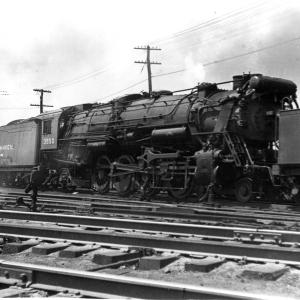 Engineer's side view of R-3  #3550 under steam between two light pacifics