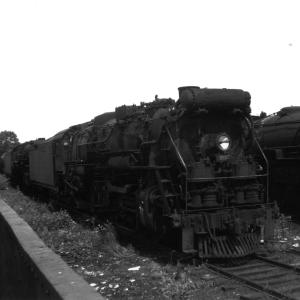 Three cylinder R-3a #3557 sitting in scrap yard at Readville Car Shops with number of other retired steam locomotives