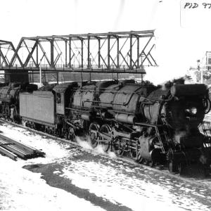 Class R-3 #3552 and R-1 #3324 have just been released by the Readville Locomotive Shops and are heading to Boston for service assignment during December 1937.  Note the Sprague Street bridge in the background.