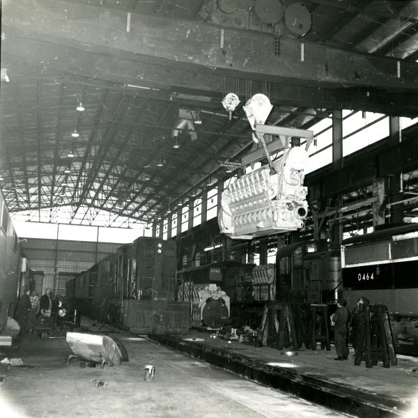 View is north to south of the interior of the new car shop with an Alco engine hanging on the bridge crane. NH 0464, 0785, 1228 - DER-3a, DERS-4