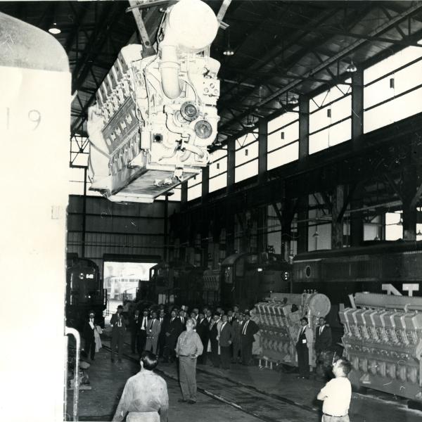 View is from the north to the south of the interior of the new car shop during a crane hoisting demonstration.