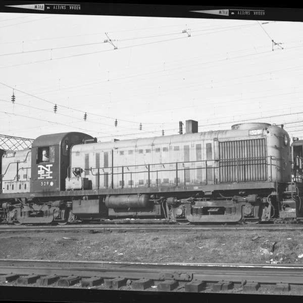 RS-3  #529  leading an FA unit under wire.  An MU car passes on a track behind the diesels