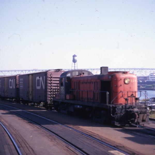 3/4 front end view of the engineer's side of RS-3 #529 on the New Haven-Central Vermont interchange track at New London - Gold Star Memorial Bridge in distant background.