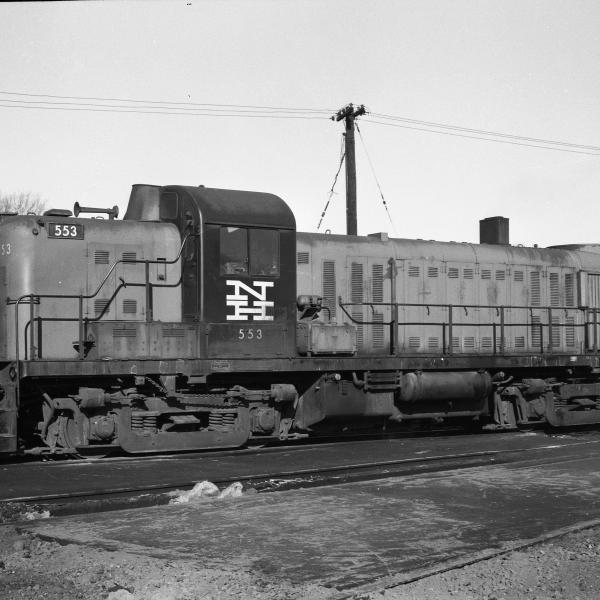 RS-3  #553 short hood side view of engineer's side.   In yard, boxcars on next track.  Locomotive is in Alpert paint