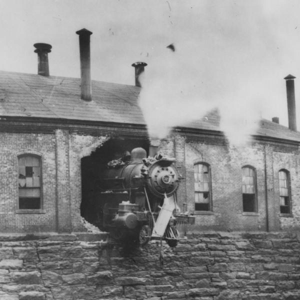 Hartford, CT roundhouse with engine #321 crashed thru the back wall with lead truck hanging over the abyss.