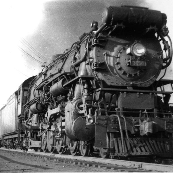 Front Right 3/4 close view of approaching freight train pulled by 3-cylinder mountain.  Postcard from Brown to Kenneth Warner.