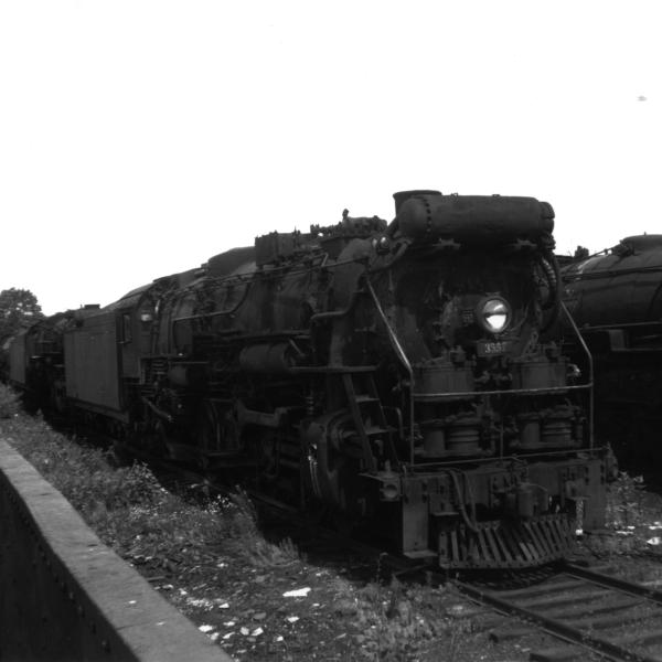 Three cylinder R-3a #3557 sitting in scrap yard at Readville Car Shops with number of other retired steam locomotives